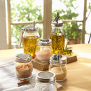 Set of glass jars with metal lids on a wooden surface with a blurred natural background