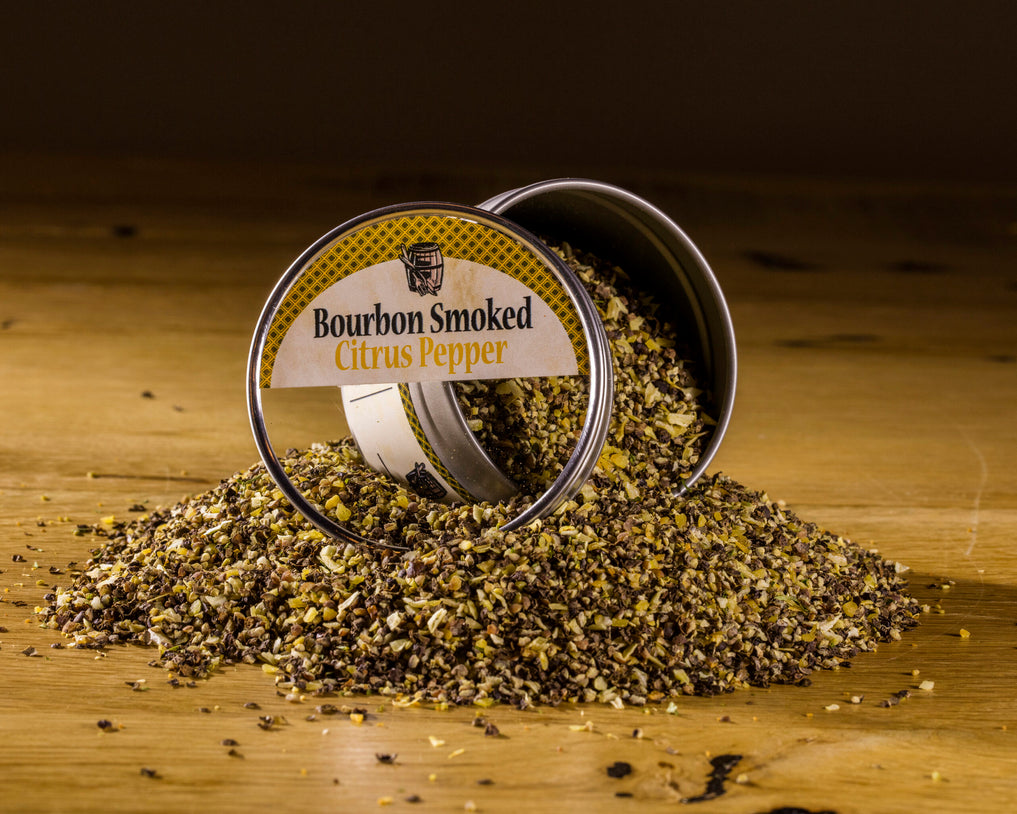 Open container of Bourbon Smoked Citrus Pepper on a wooden surface