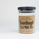 Sourdough starter jar with a brown label on a white background