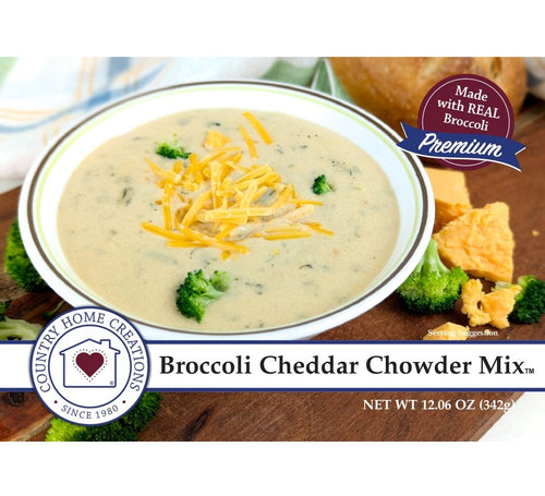 Broccoli Cheddar Chowder Mix packaging with a bowl of soup and cheese on a wooden surface.