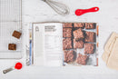 The Zingerman's Bakehouse cookbook open to a page featuring a brownie recipe and an image of browines.
