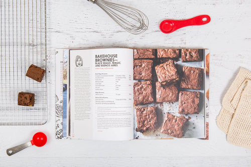 The Zingerman's Bakehouse cookbook open to a page featuring a brownie recipe and an image of browines.