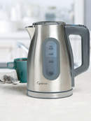 Stainless steel electric kettle with digital display on a kitchen counter