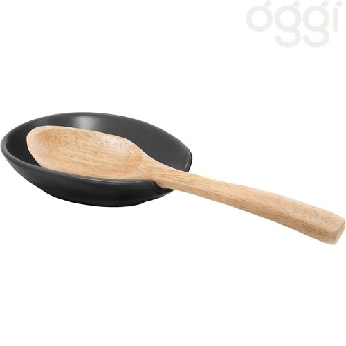A matte black spoon rest with a light natural wood spoon resting inside it, shown on a plain white background.