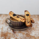 Cup of coffee with biscotti on a wooden surface