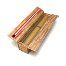 Parchment paper dispenser with a roll of parchment paper inside on a white background