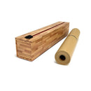 Parchment paper dispenser next to a roll of parchment on a white background