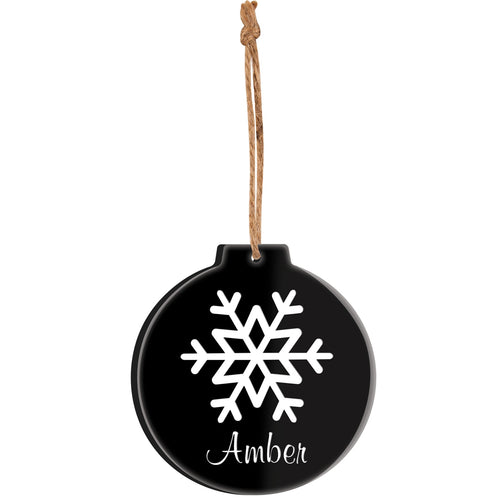 Black ornament with white snowflake and 'Amber' text, hanging on a white background