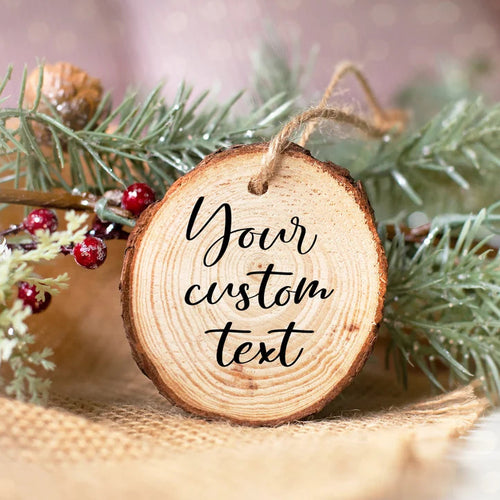 Wooden ornament with 'Your custom text' engraved, surrounded by greenery