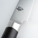 Close-up of a chef's knife with a black handle on a white background
