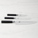 Set of three knives with black handles on a white background