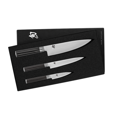 Set of three knives in a black box with a brand logo on a white background