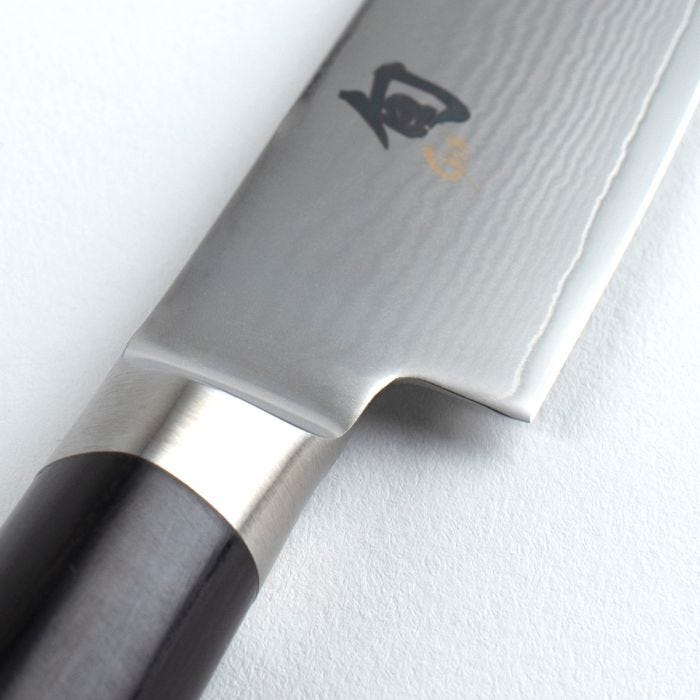 Close-up of a chef's knife with a brand logo on a white background