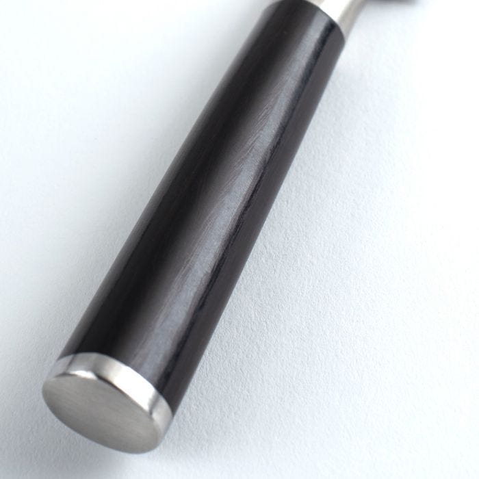 Close-up of a knife handle with a silver base on a white background