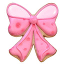 Cookie shaped like a pink bow with pink icing on a white background