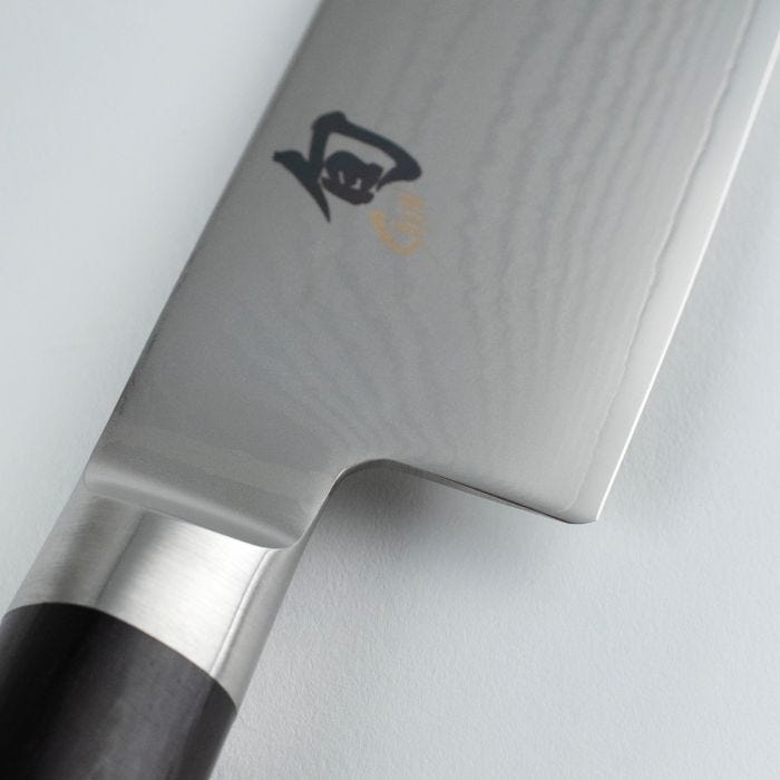 Close-up of a chef's knife with a brand logo on a white background