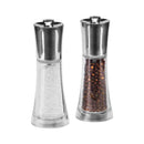 A set of two stainless steel salt and pepper mills with clear acrylic bodies, one filled with whole black peppercorns and the other with coarse sea salt.