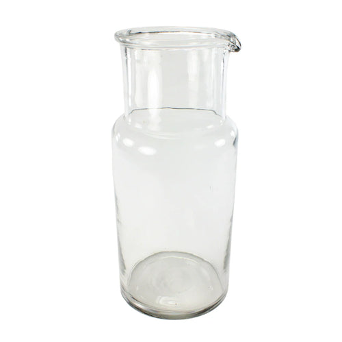 Clear glass carafe on a white background