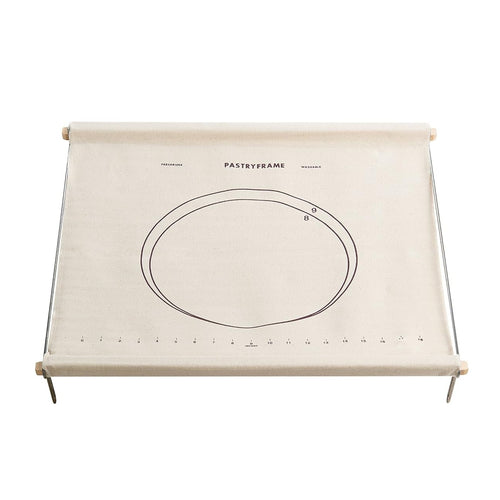 A canvas pastry frame with a printed circular template and measurement markings, mounted on a metal stand with wooden rollers at the top, shown against a plain white background.