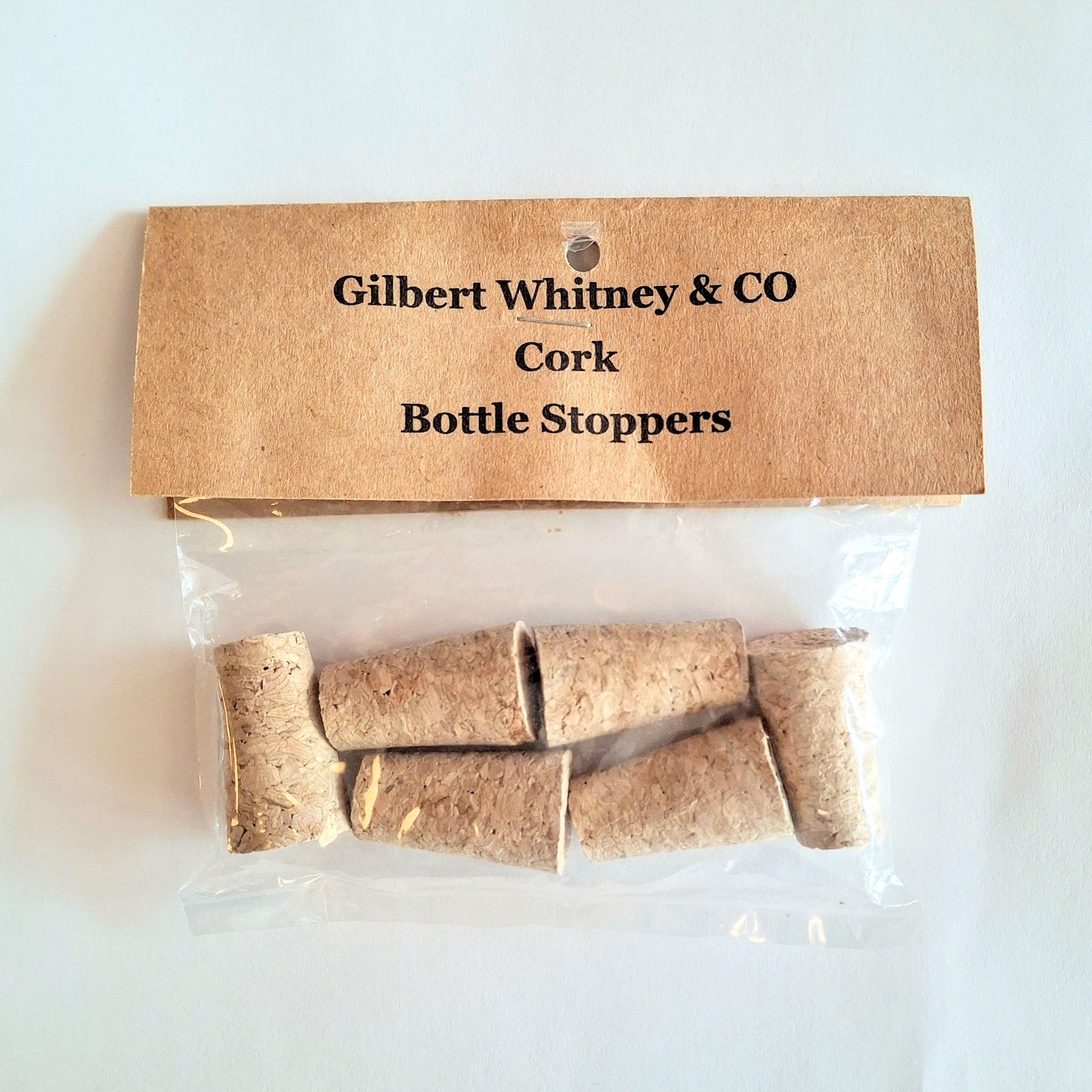 Packaged cork bottle stoppers with a cardboard label on a white background