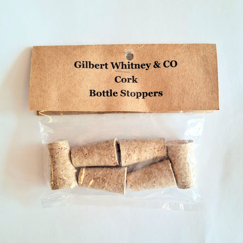 Packaged cork bottle stoppers with a cardboard label on a white background