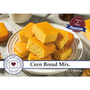 Cornbread mix packaging with cornbread pieces on a plate
