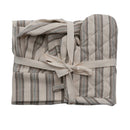 A children's kitchen apron, chef hat, and oven mitt with striped patterns, tied together with a bow.