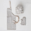 A children's kitchen apron, chef hat, and oven mitt with striped patterns