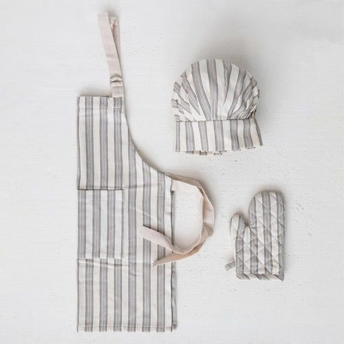 A children's kitchen apron, chef hat, and oven mitt with striped patterns