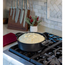 Black pot on a stove with food inside, kitchen setting
