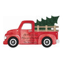 A decorative wooden sign in the shape of a red pickup truck with a Christmas tree and 'All Harsa's Home for Christmas' text, indicating it's a holiday pickup truck sign.