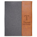 Notebook with gray cover and brown leather side, personalized with 'Thomas Sales Manager'.