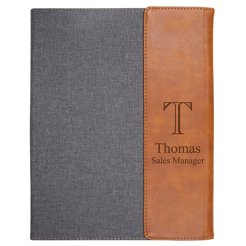 Notebook with gray cover and brown leather side, personalized with 'Thomas Sales Manager'.