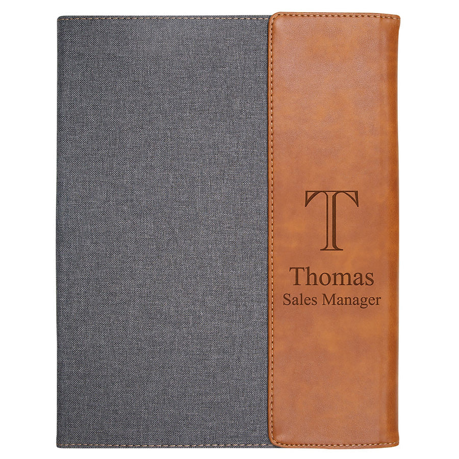 Notebook with gray cover and brown leather side, personalized with 'Thomas Sales Manager'.