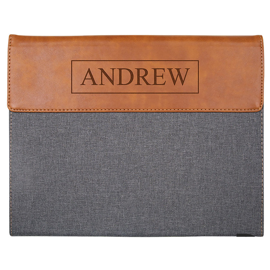 Gray padfolio with brown leather wrap and 'ANDREW' engraving on a white background