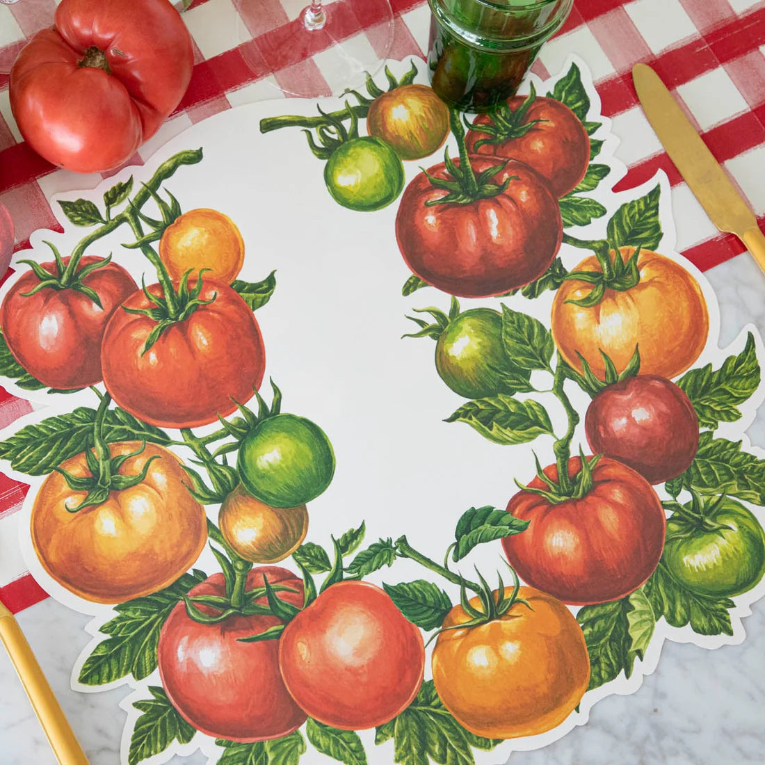 A place setting with tomato placemat, and red check table runner.