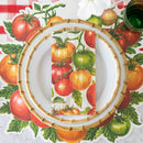 A place setting with illustrated tomato placemat, red check table runner, and tomato napkin.