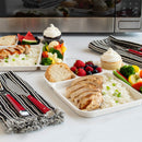 Dinner setup with plates of food, including bread, salad, and desserts, on a kitchen counter.