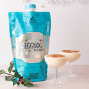 Eggnog in a bag with two glasses of eggnog on a white background