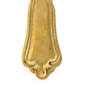 Decorative brass spoon handle on a white background