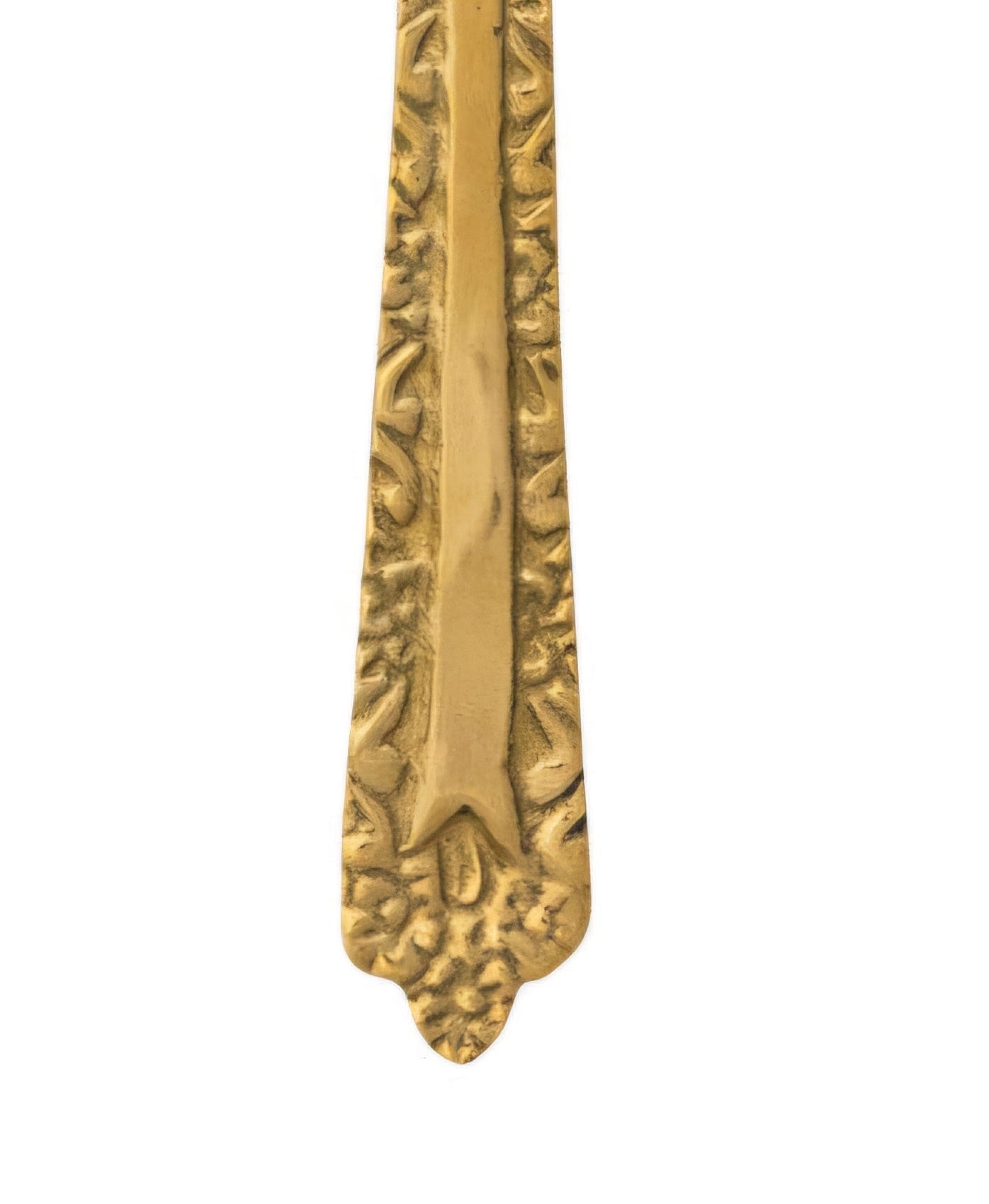 Decorative brass spoon handle on a white background
