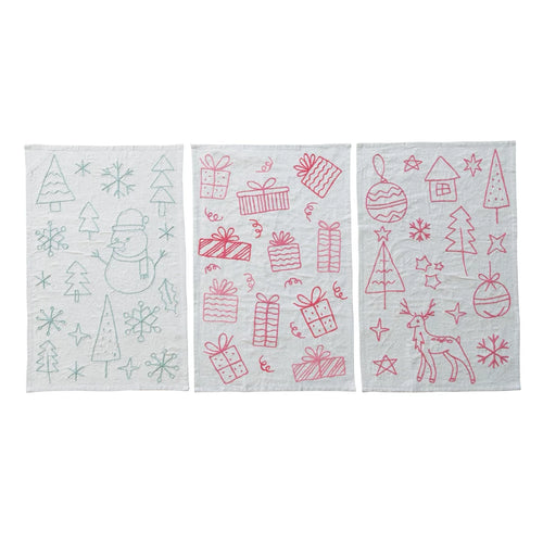 Three Christmas-themed towels with red designs on a white background
