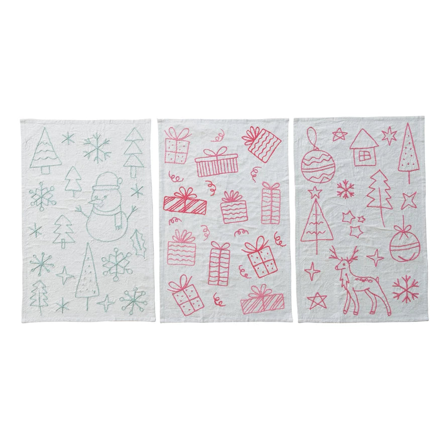 Three Christmas-themed towels with red designs on a white background