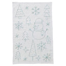 Tea towel with embroidered snowman, trees, and snowflakes on a white background