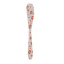 White spoon with orange leopard pattern on a white background