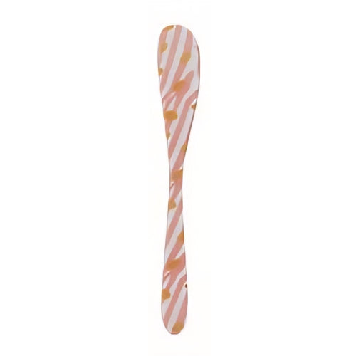 Butter knife with pink and orange pattern on a white background