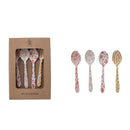 Set of four patterned spoons with a cardboard box packaging on a white background