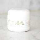 White jar with 'Bella Cucina' label on a marble surface
