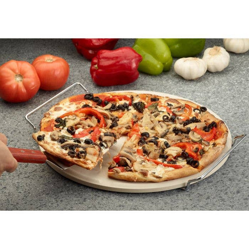 Pizza with various toppings on a stone surface with vegetables