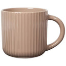A pale pink stoneware mug with fluted ridges and a handle on the right side.